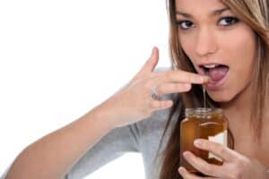 Woman Eating Honey With Finger